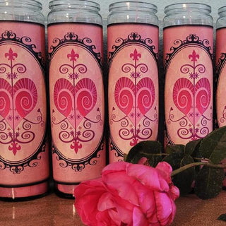 pink glass encased candles with Erzulie Freda's ritual symbol shaped like a heart.