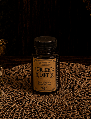 Bottle of '3 Churches Dirt' on a textured surface with a dark background