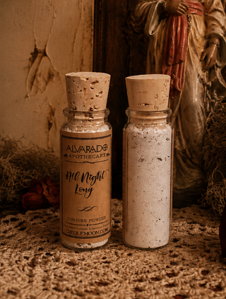 Two glass bottles with cork stoppers on a textured surface. The left bottle has a tan label reading 'ALVARADO APOTHECARY All Night Long' and the right bottle contains white speckled powder.
