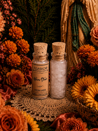 Two glass bottles filled with alum stone with cork stoppers on a doily surrounded by autumn flowers.