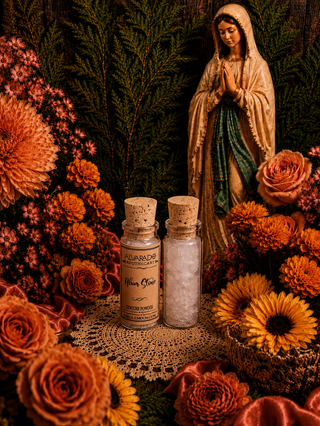 Two small bottles of alum stone with cork stoppers on a doily surrounded by flowers and a religious statue.