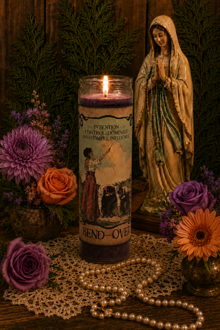 Candle with a figurine of a woman and flowers on a wooden surface