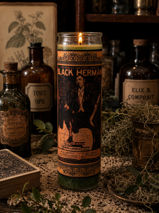 Candle with vintage design and text, surrounded by old bottles and herbs on a rustic surface.