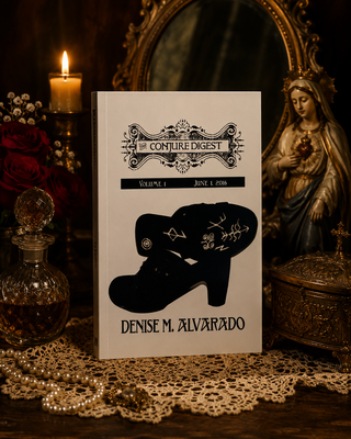 Book titled 'The Conjured Digest' by Denise M. Alvarado on a table with decorative items.