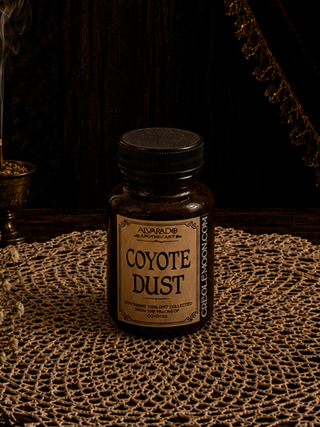 Bottle of 'Coyote Dust' on a textured surface with a dark background