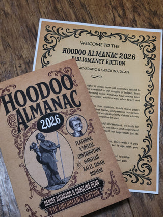 Two 'Hoodoo Almanac 2026' books on a wooden surface