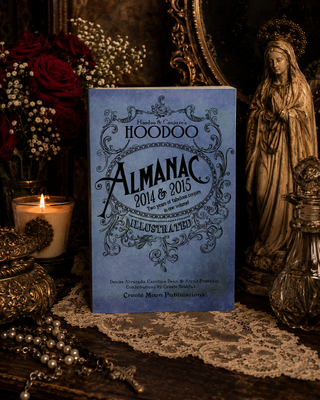 Hoodoo Almanac 2014 & 2015 book with candles, flowers, and a statue on a dark background