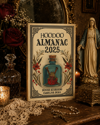 Hoodoo Almanac 2025 book with decorative elements on a table.