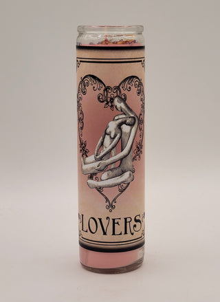 Candle with artistic design and text on a plain background