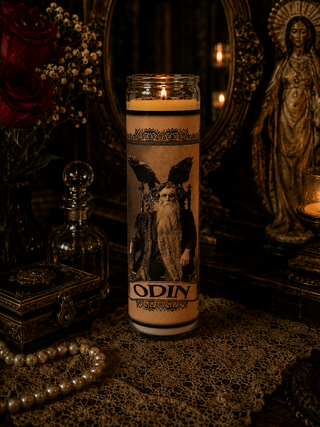 Candle with an illustration of Odin in a mystical setting with flowers and a statue.