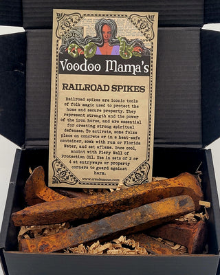 Box of Voodoo Mama's Railroad Spikes with packaging label and rusty spikes inside.