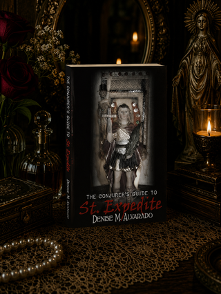 Book titled 'The Conjurer's Guide to St. Expedite' by Denise M. Alvarado in a mystical setting with candles and statues.