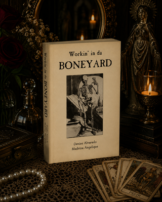 Book titled 'Workin' in da Boneyard' with a skeleton illustration on a dark background with candles and decor.