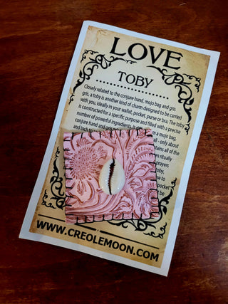 Card with 'Love Toby' design and text on a wooden surface