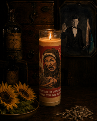 Candle with a graphic design on a dark background with sunflowers and bottles.